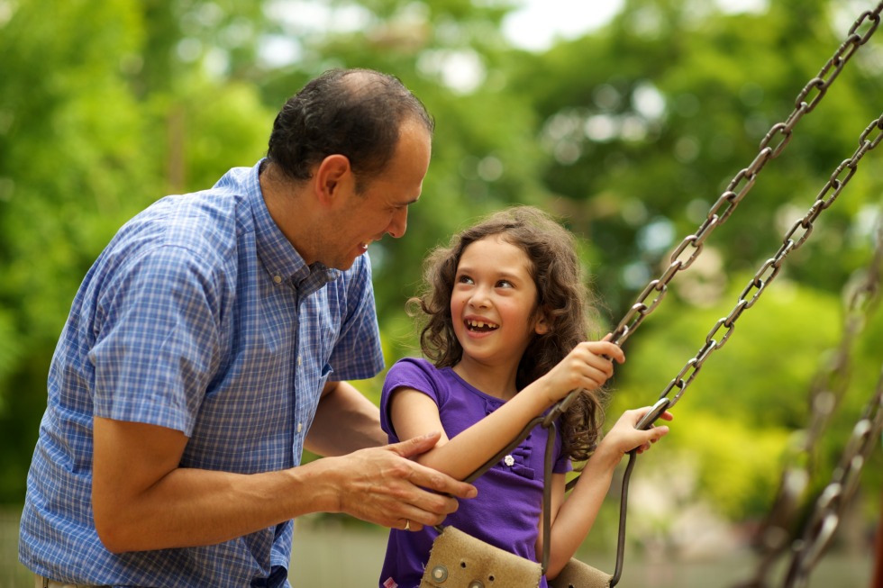 A bearded man with a child