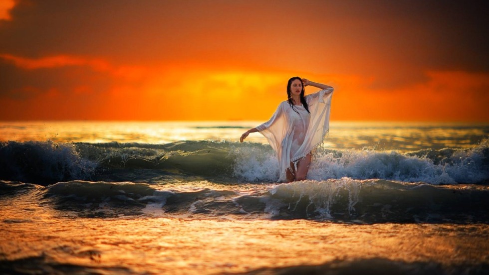 Girl at sunset by the sea