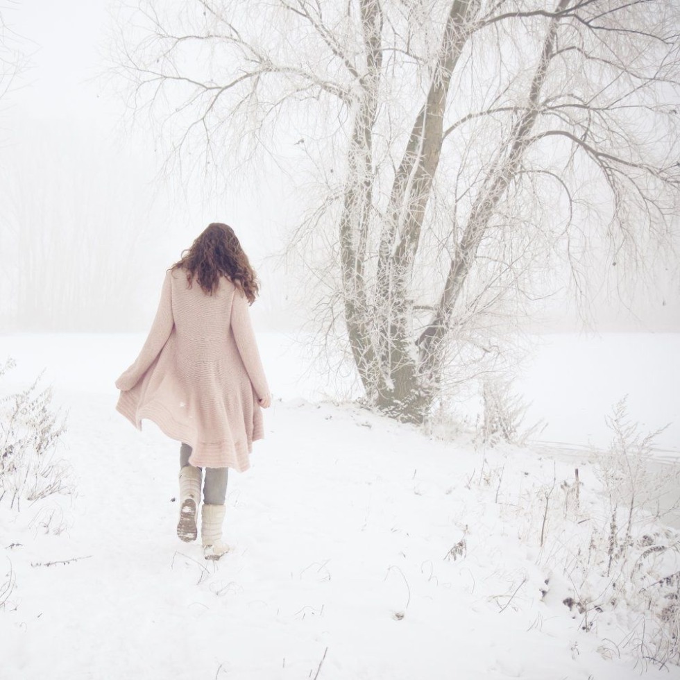 The girl walks in the snow