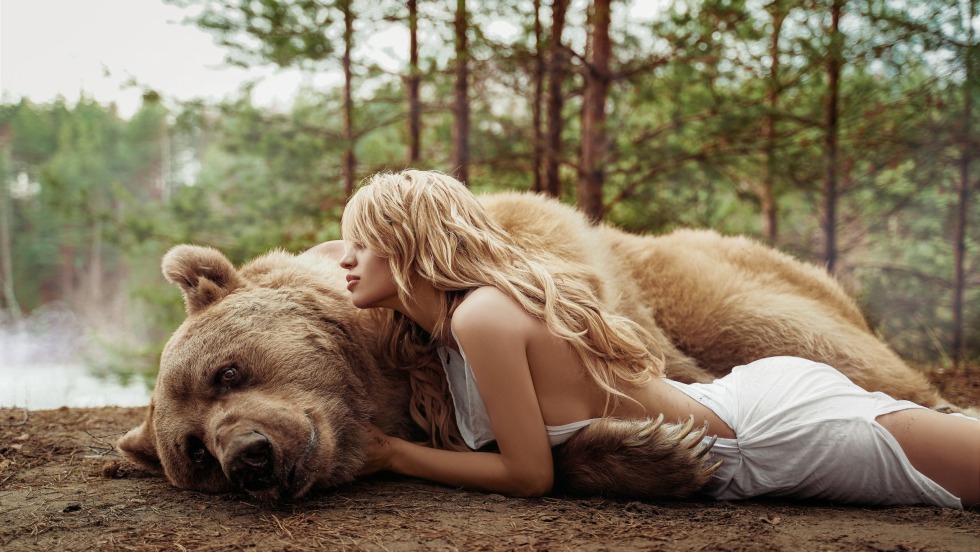 The bear hugs the girl