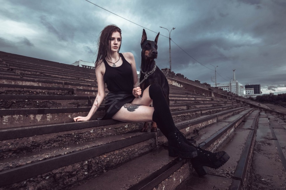 Photo shoot on an abandonment with Doberman in a beautiful dress