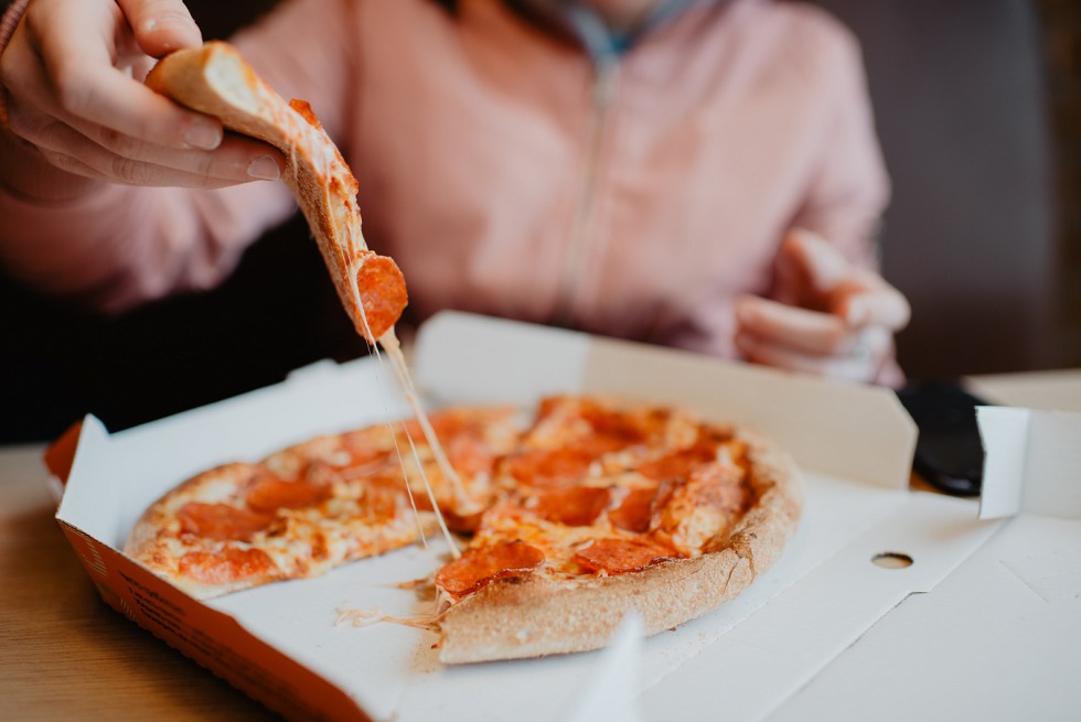 A piece of pizza in the hand