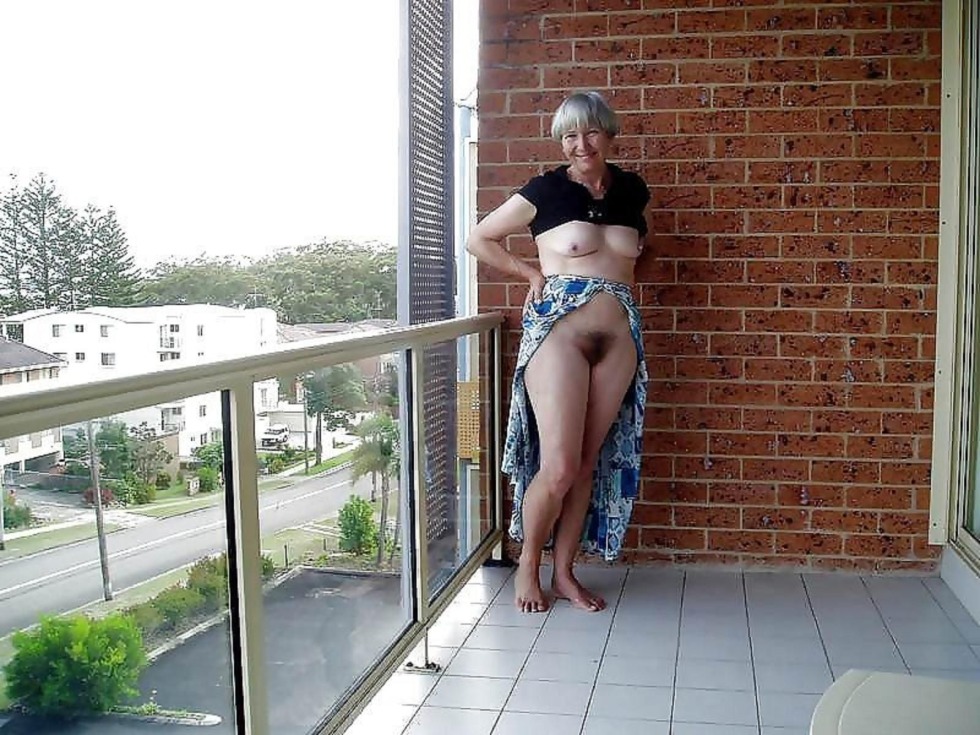 Naked women in the windows of houses