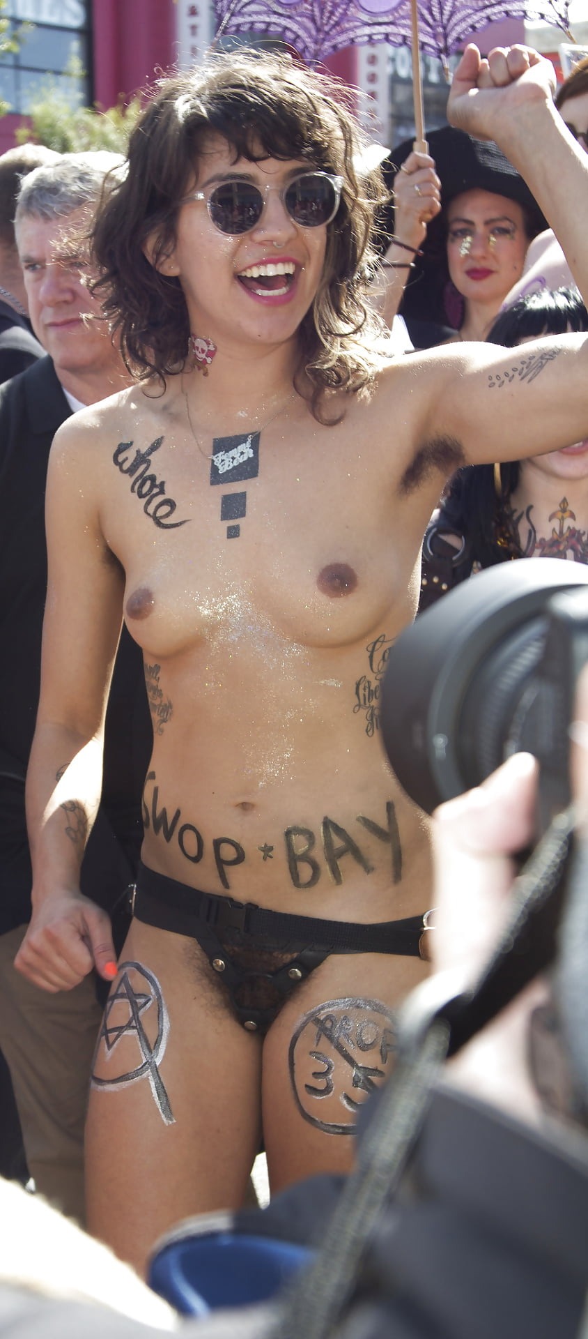 Naked chick in front of the crowd at the factory workers