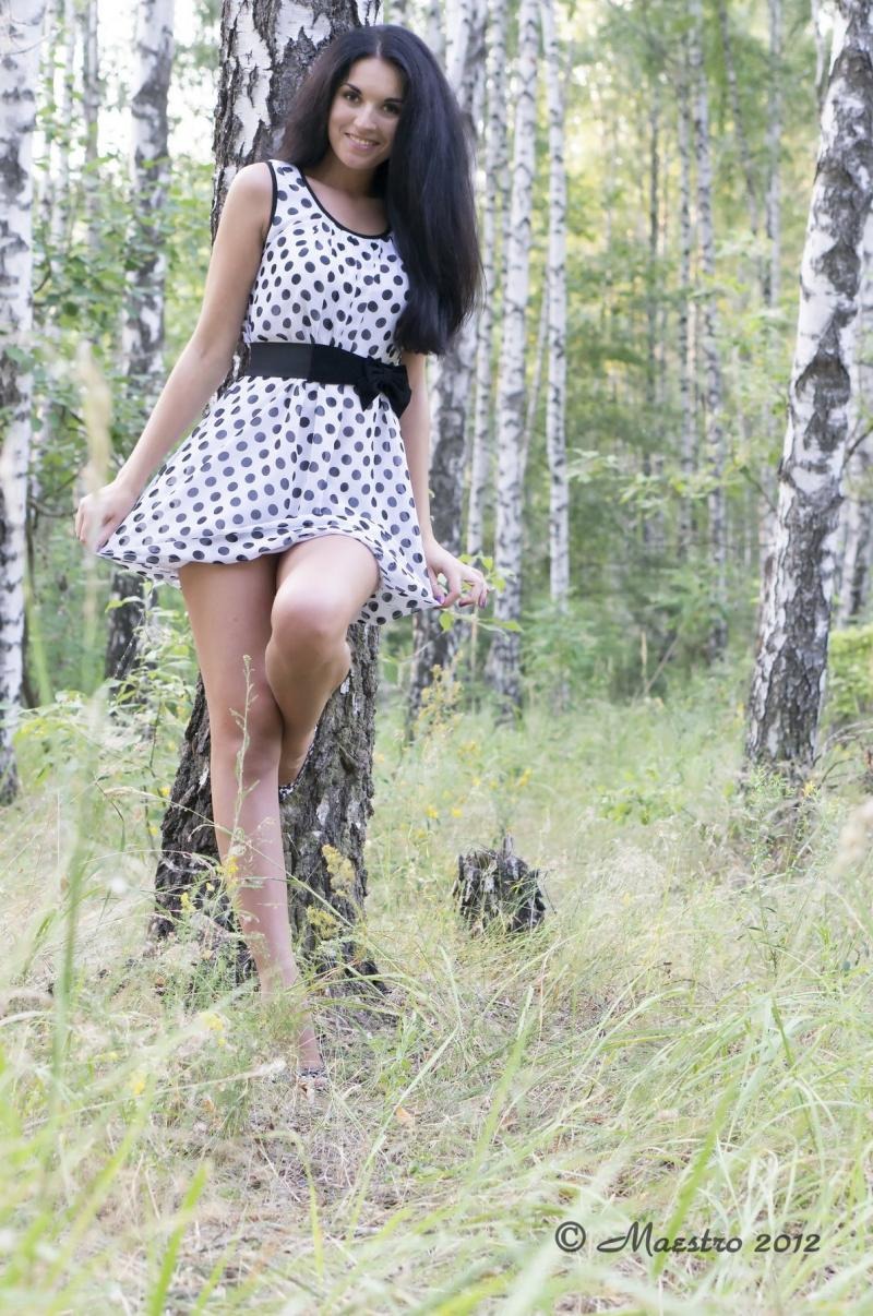 Girl in a sundress in the forest