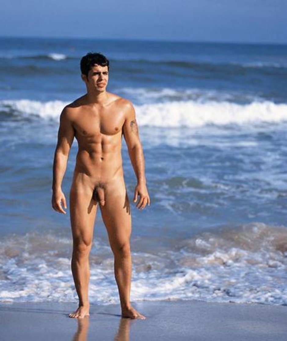 Naked guy with a big dick on the beach