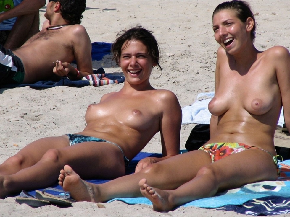 Three girls topless on the beach