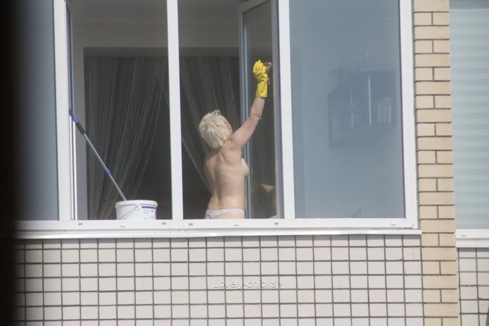 Girl topless on the balcony