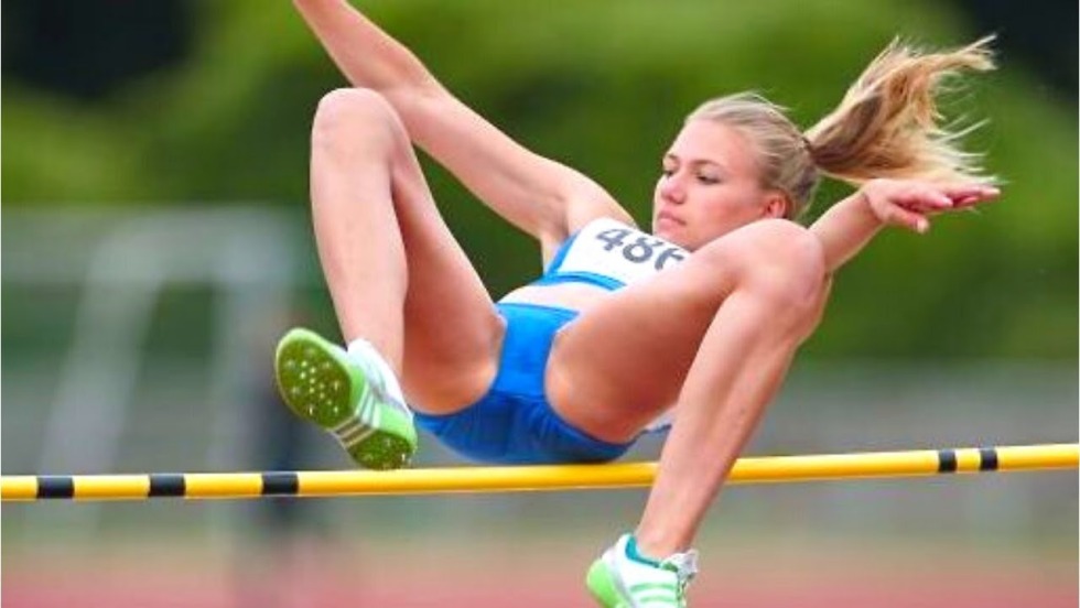 Naked gymnast on the horizontal bar