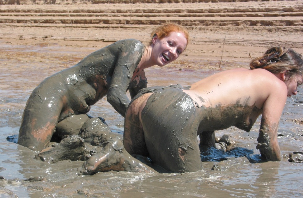 Naked women bathe in mud