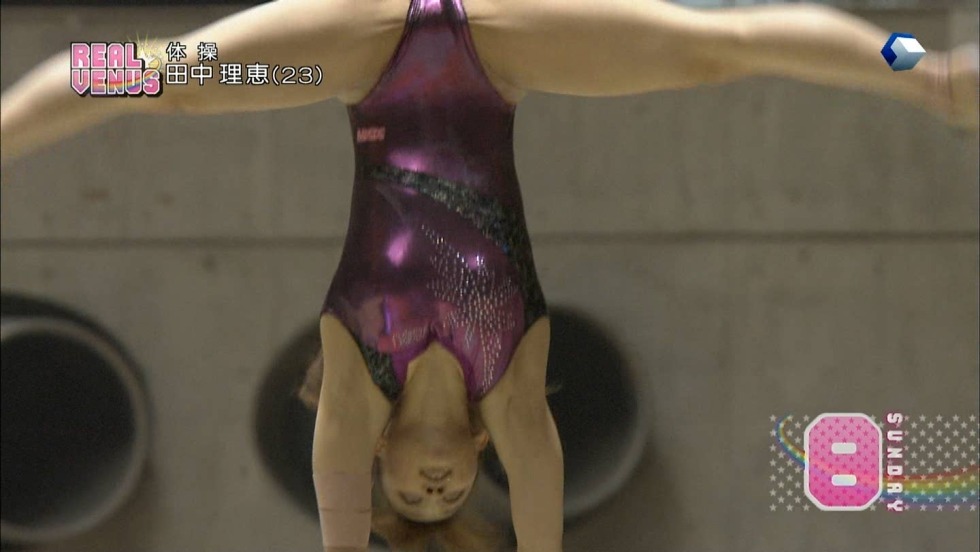 The silhouette of the gymnast on the crossbar