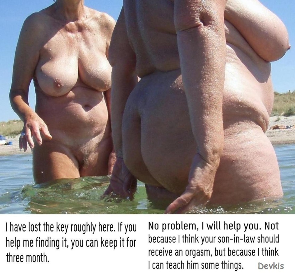 Naked mother with daughter on the beach
