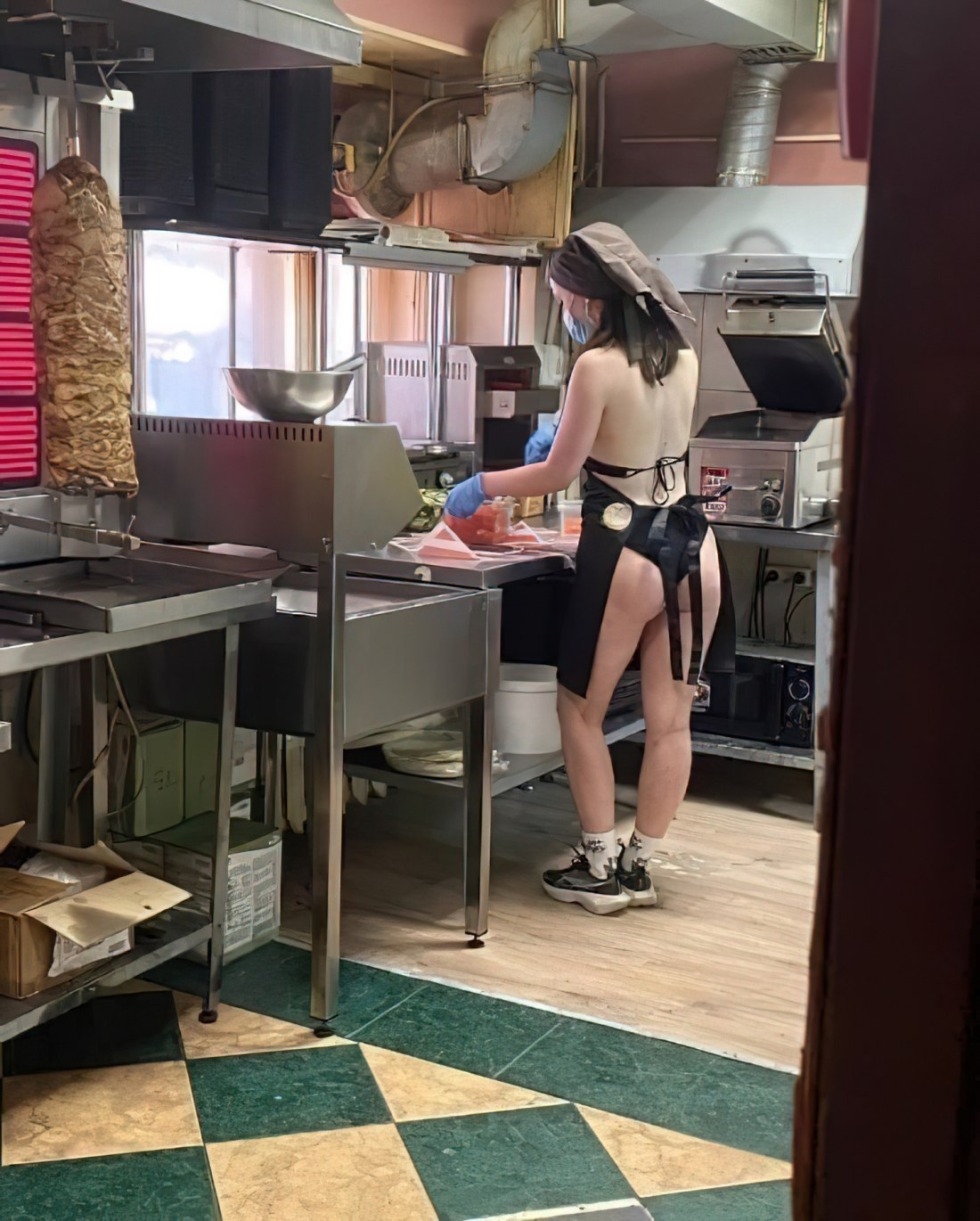 The girl undresses in a cafe