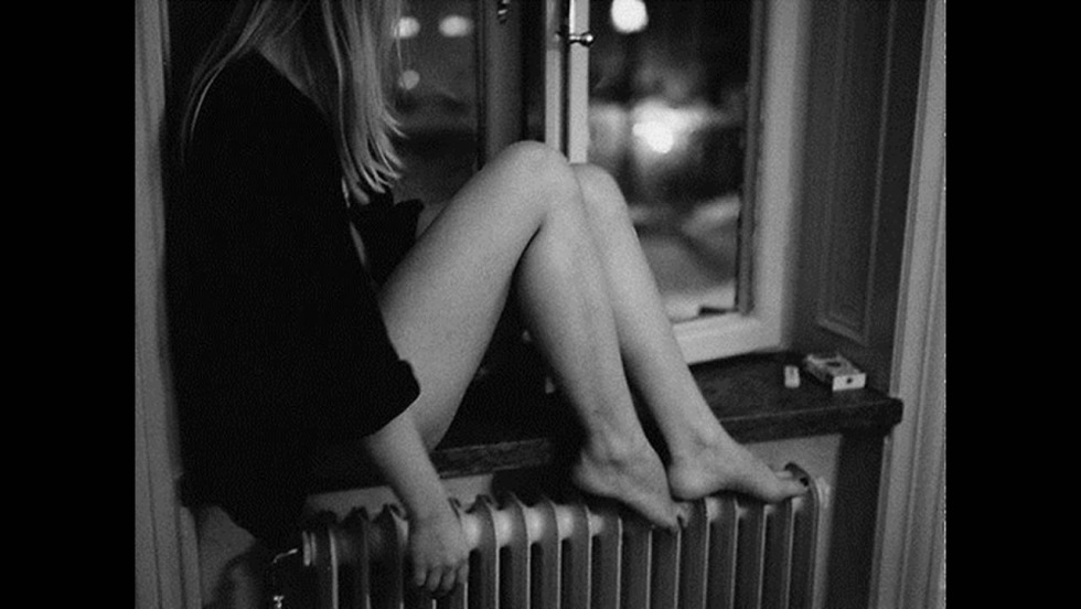 Naked women in the windows of houses