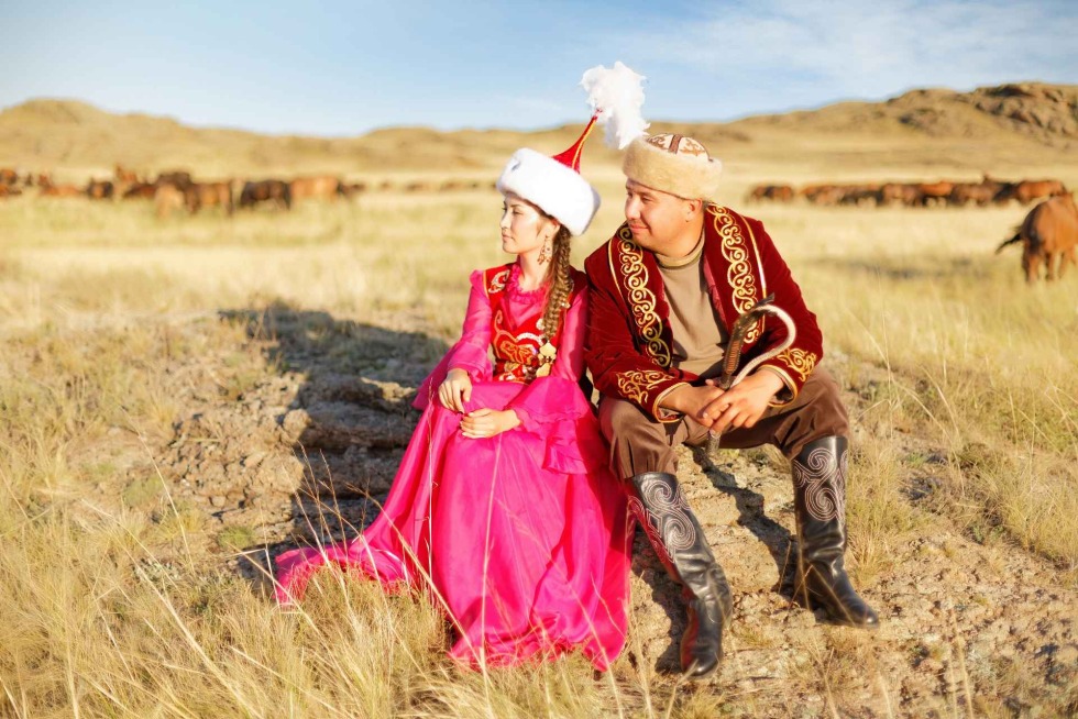 Kazakh in national clothes in the steppe