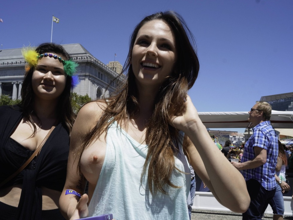 The girl shows her breasts in public