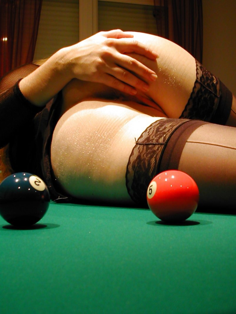Undresses on a billiard table