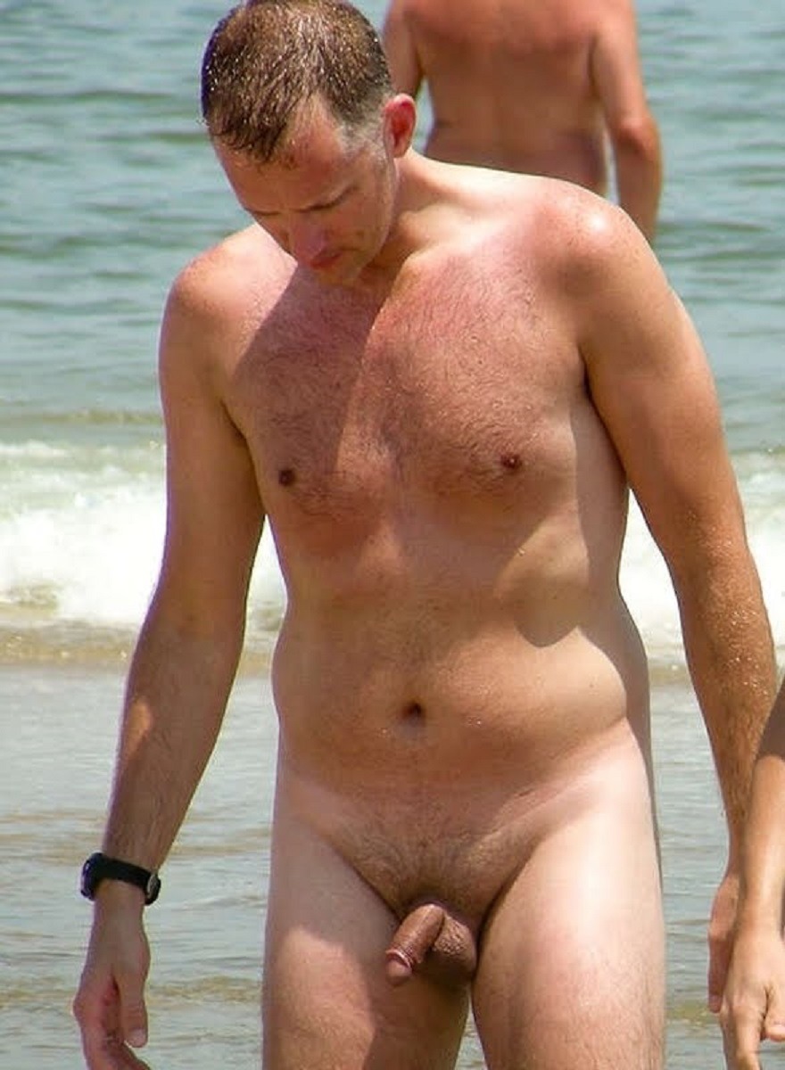 Naked man with a small member on the beach
