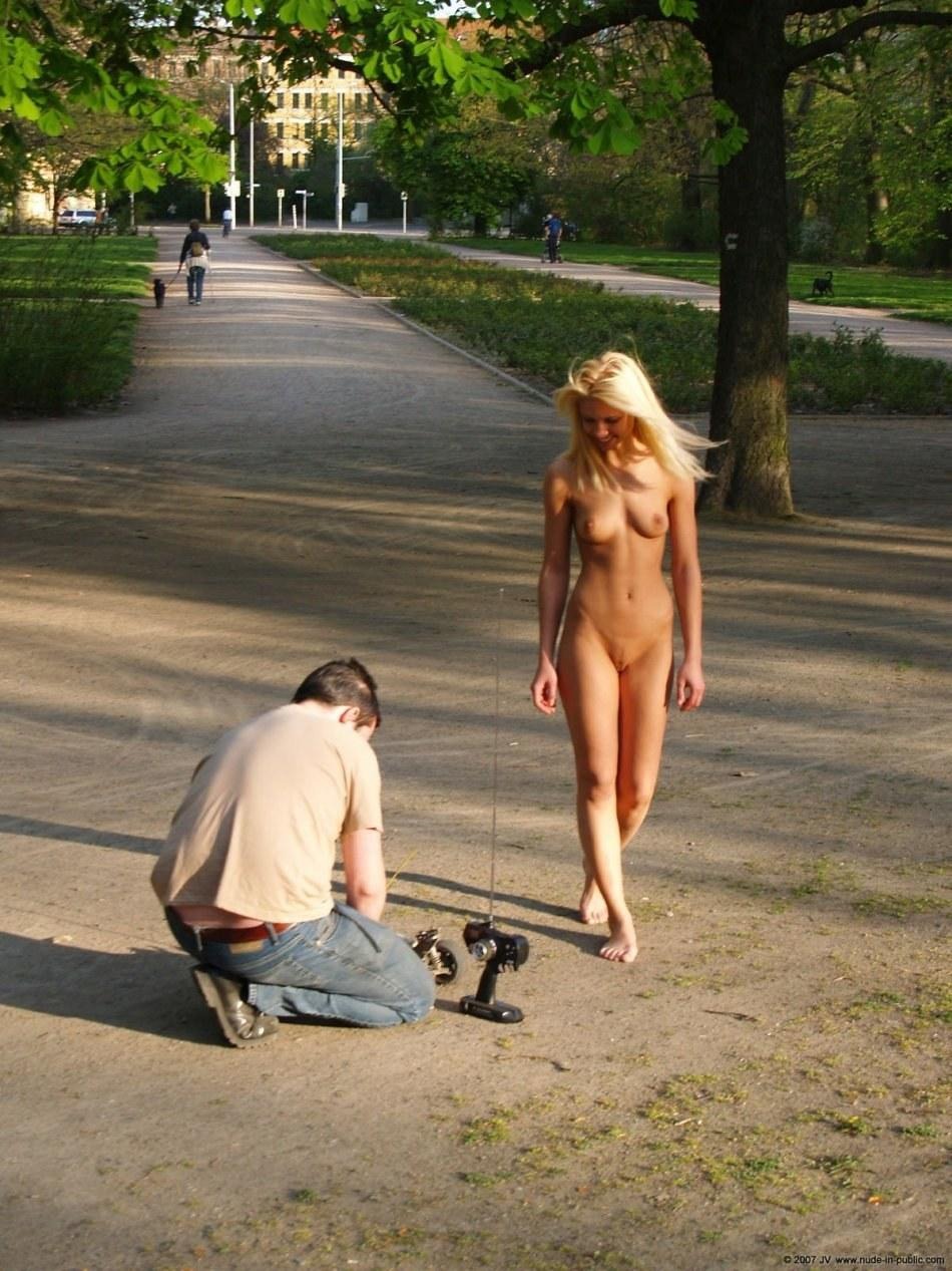 Blonde girl stripping in the street