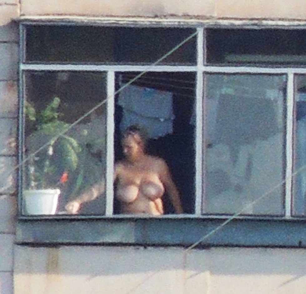 Naked women in the windows of houses
