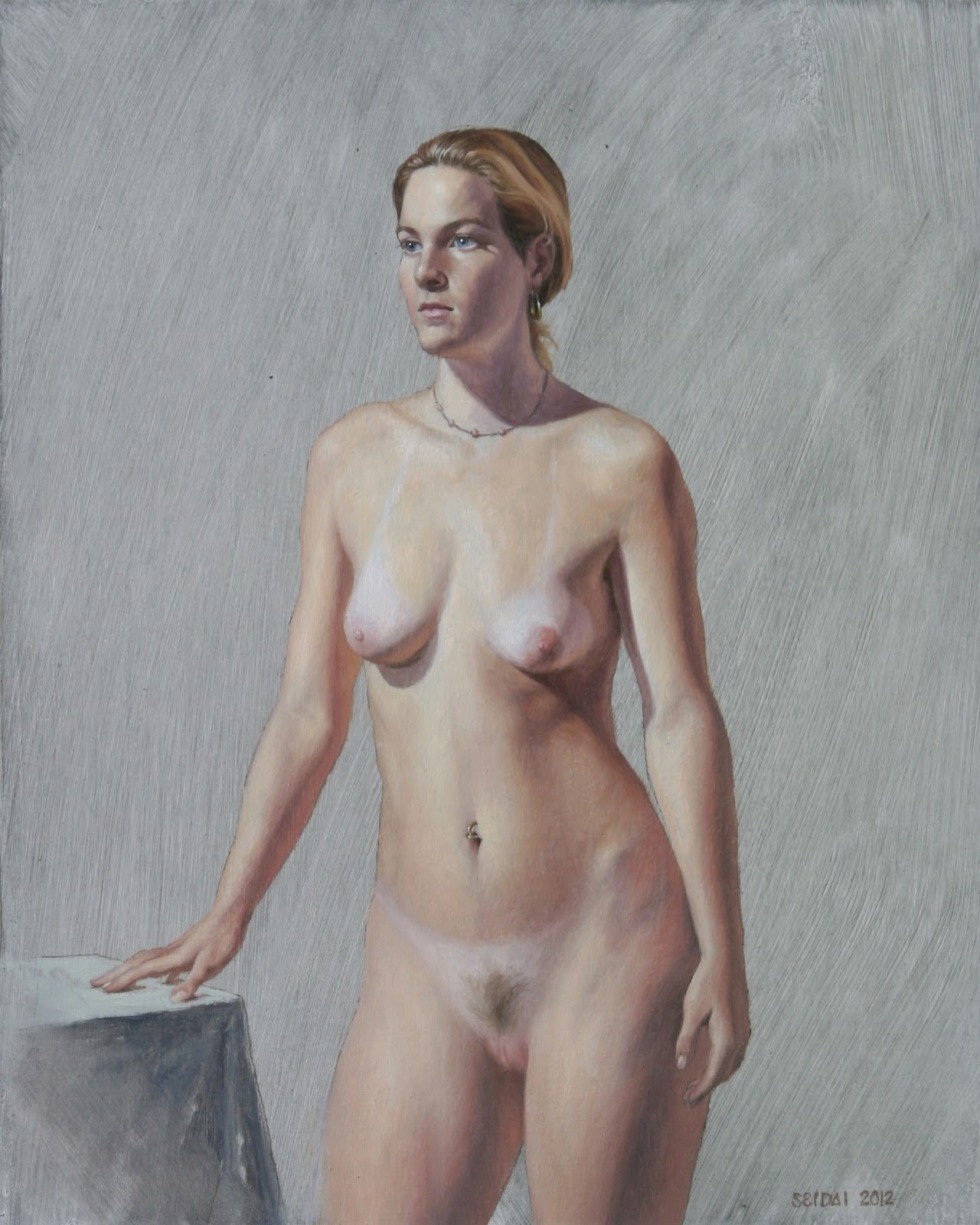 Naked women pose an artist