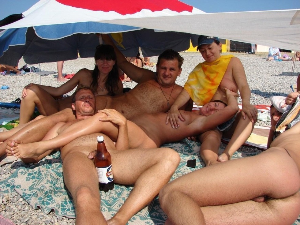 Swingers on a public beach