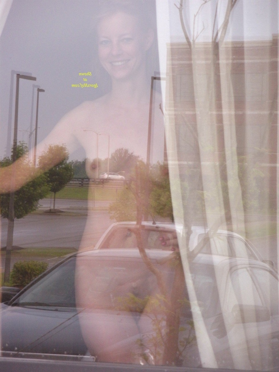 Naked woman in the window opposite