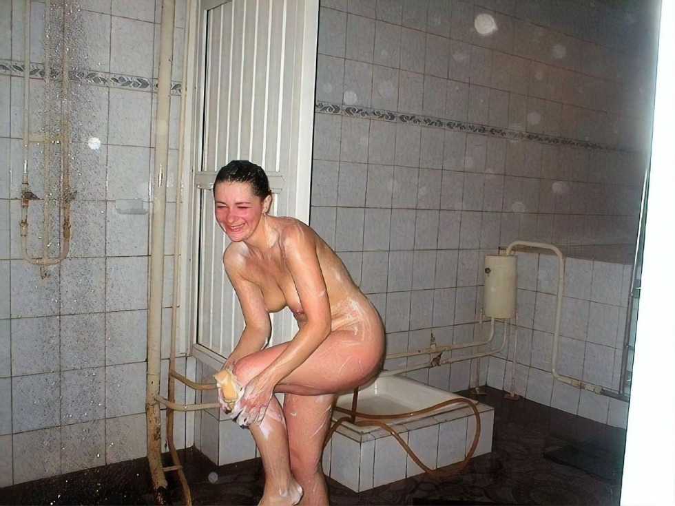 Naked women wash in a sauna in a shower