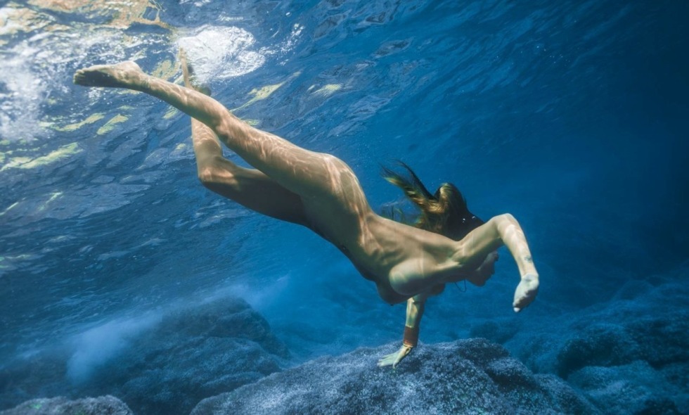 Naked women jump into the water