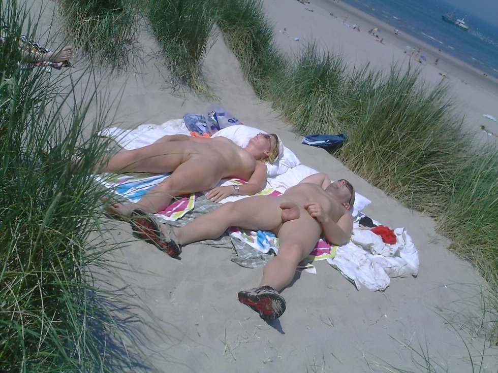 A guy with a girl is sunbathing naked