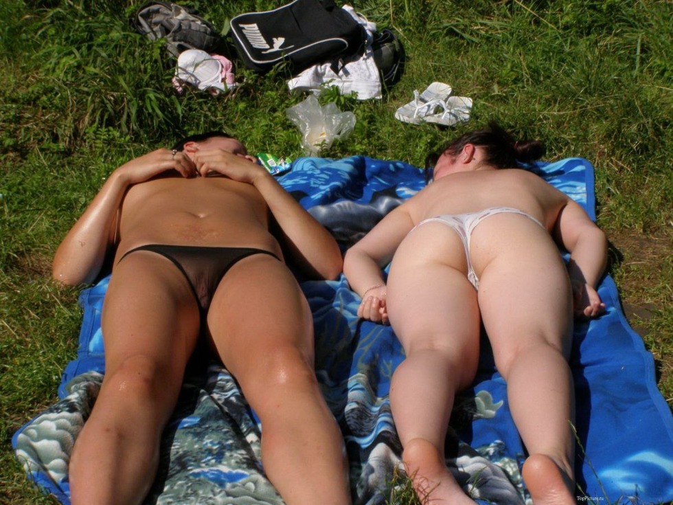 Girls sunbathe in nature peeping