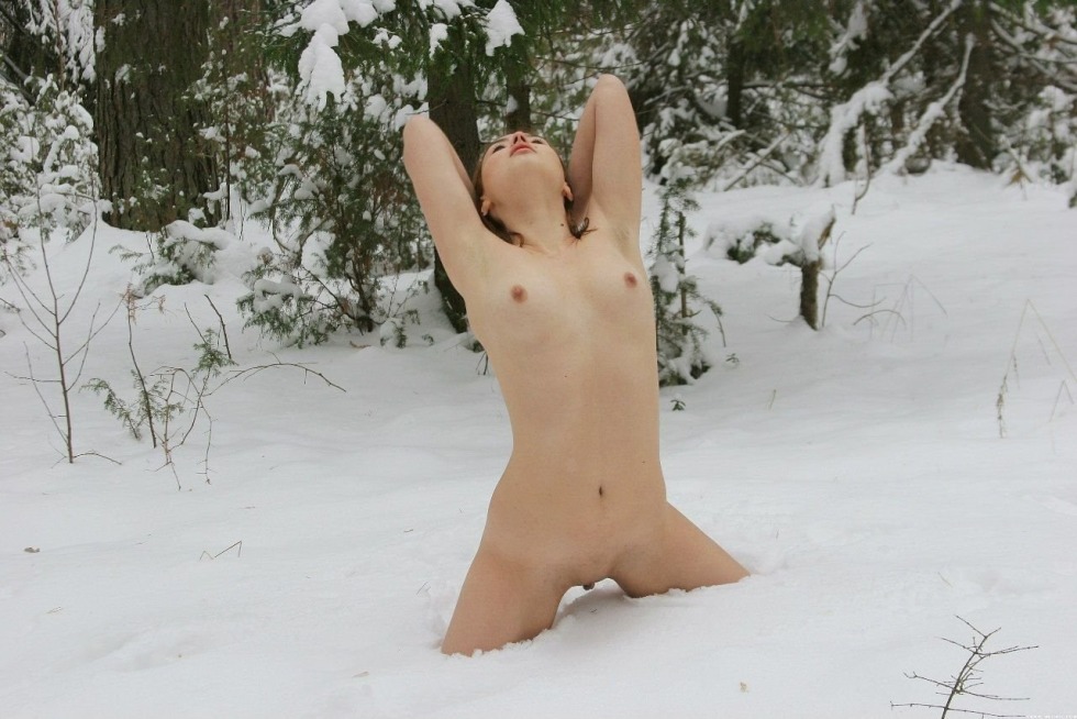 Naked woman is lying in the snow