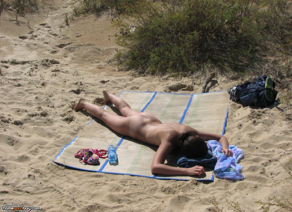 Naked sunbathing on his stomach