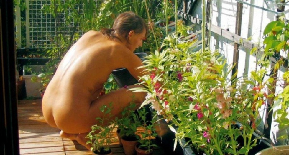 Naked in the country in a greenhouse