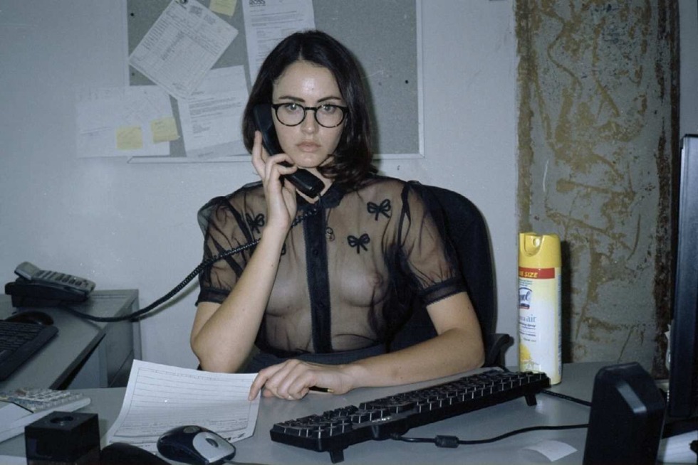 The girl undressed in the office