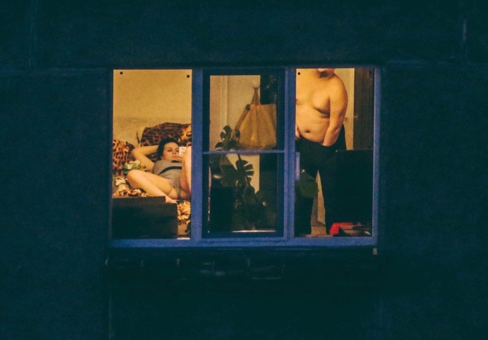 Naked women in the windows of houses