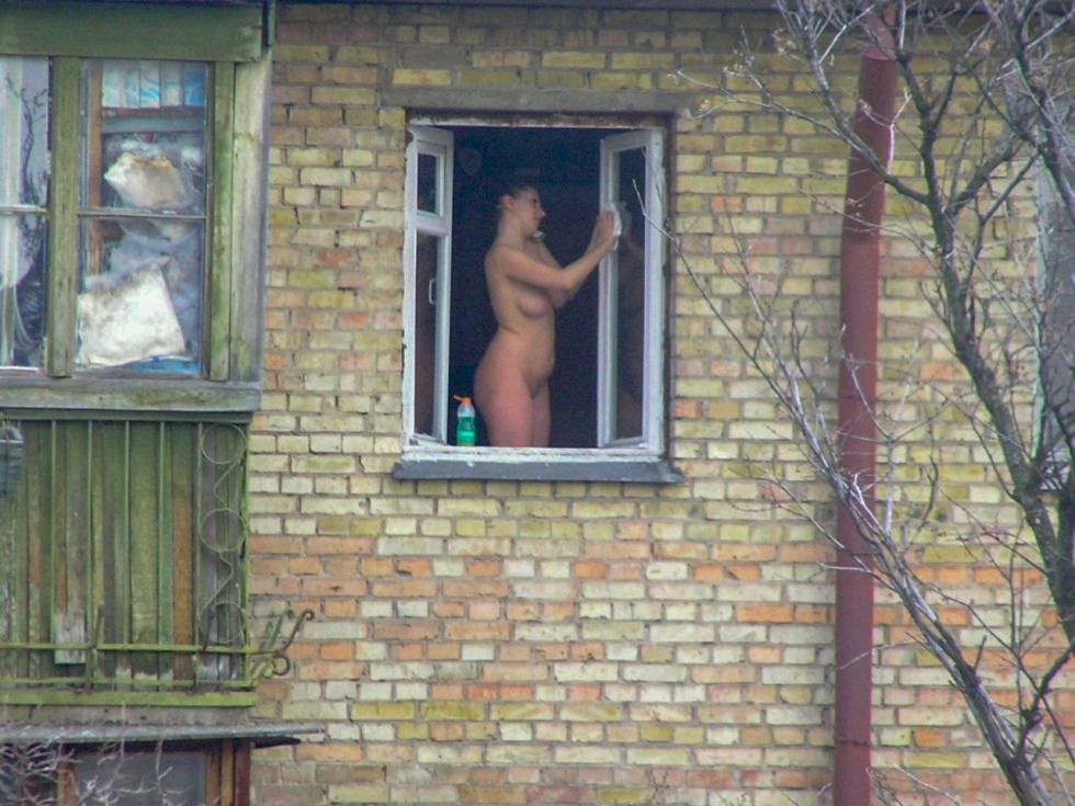 Naked women in the windows of houses