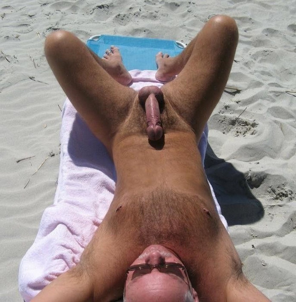 Male dicks standing on the beach