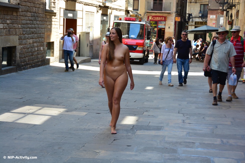 Naked woman walks along the street