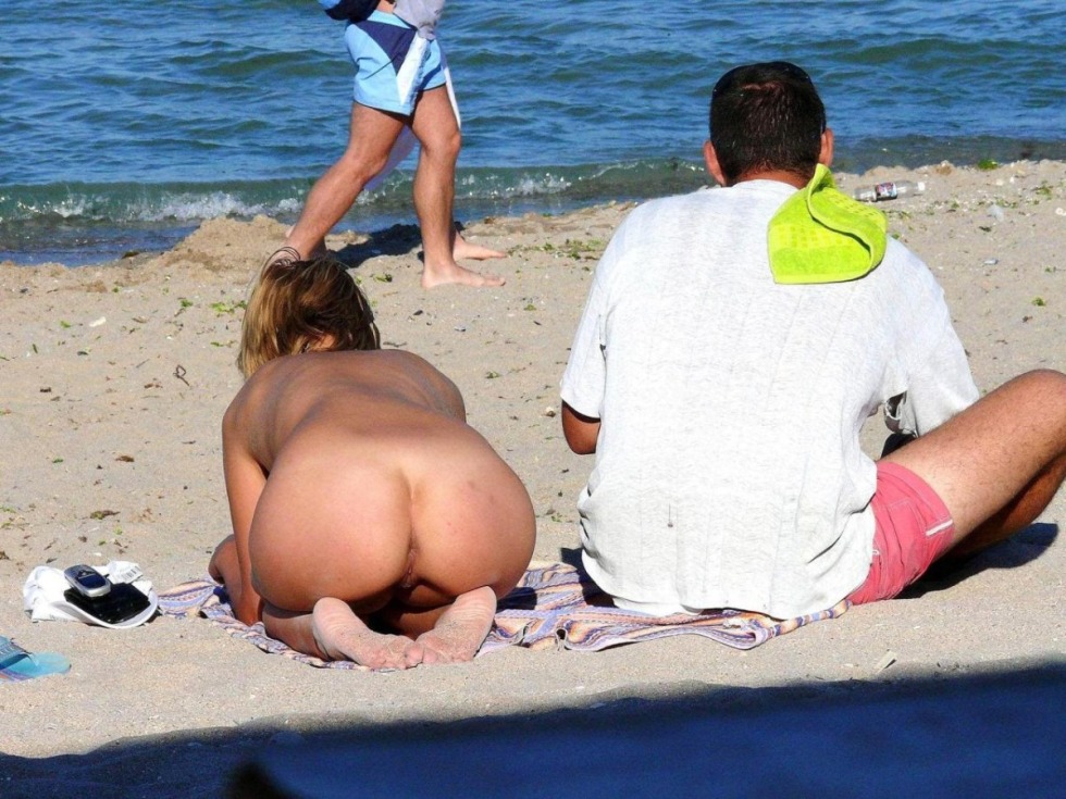 Anus in thongs on a public beach