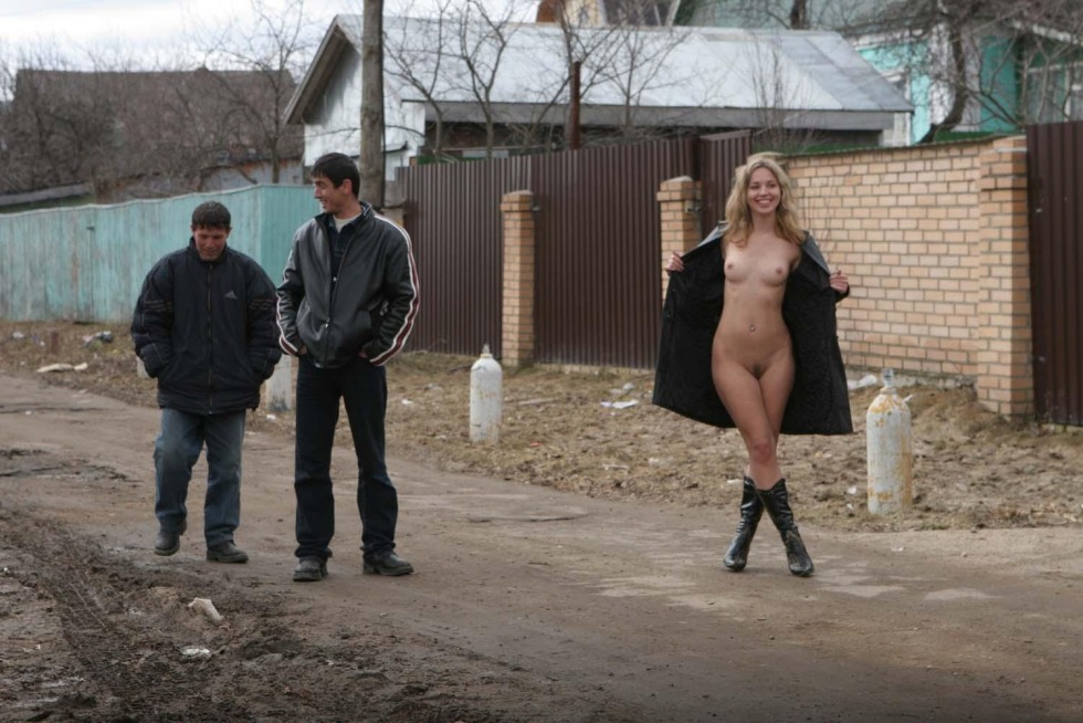 Naked woman on the street with men