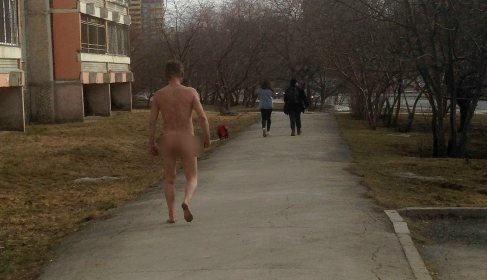 A naked guy walks down the street