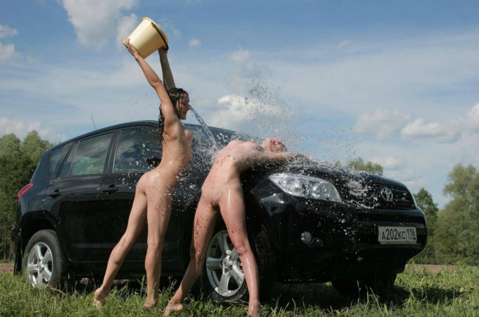 Naked in nature near a car