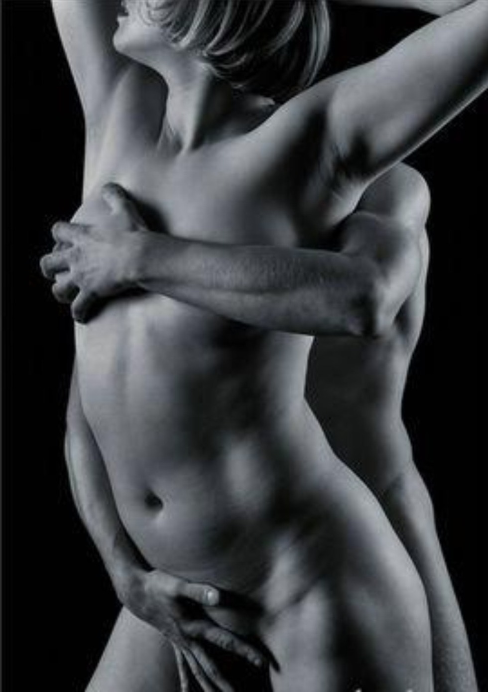 A man hugs a naked woman