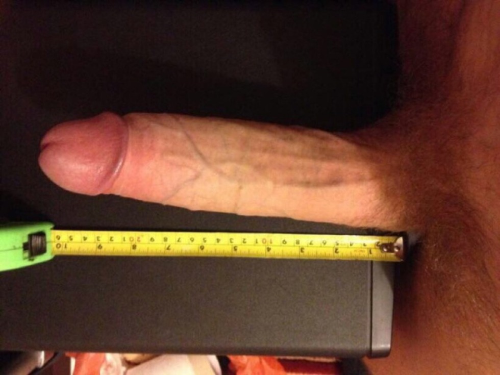 Male penis with a ruler