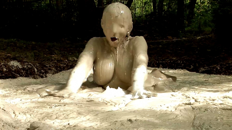 Woman with huge breasts in mud