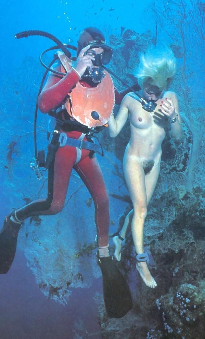 Naked women with fins underwater
