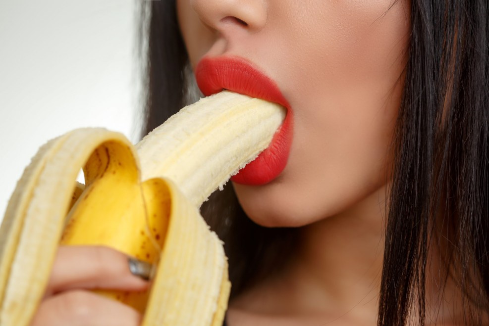 Girl with a banana in her mouth
