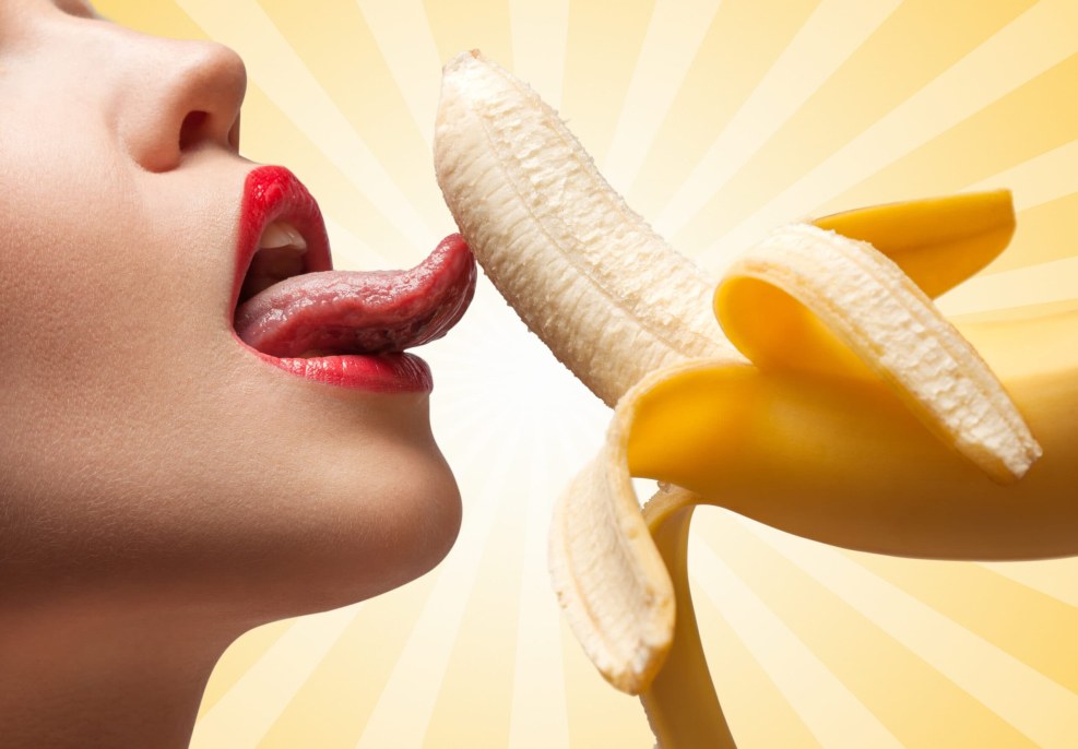 Girl with a banana in her mouth