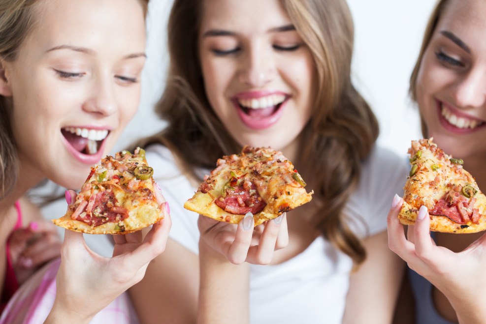 The girl eats delicious pizza